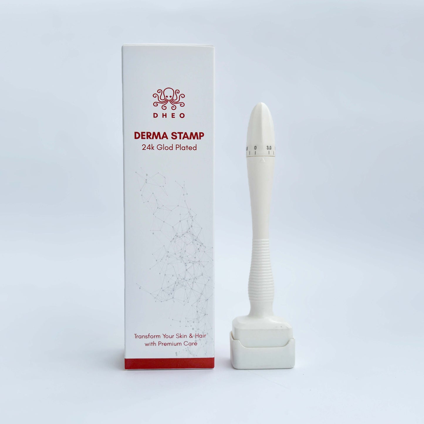 DHEO 24K gold-plated derma stamp device displayed next to its product box.