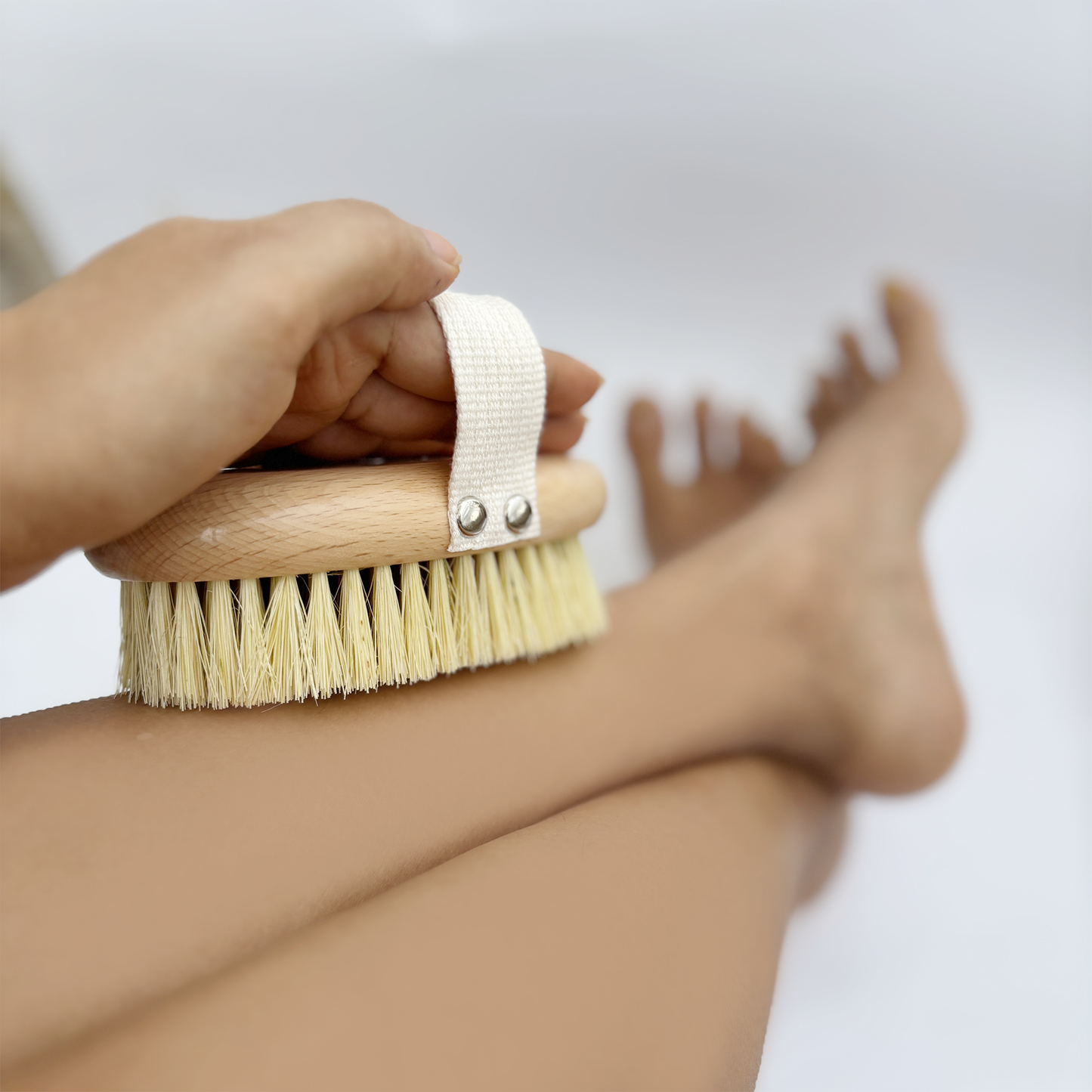 Made with sisal bristles, a wooden handle, and a cotton strap, this dry body brush boosts circulation and exfoliates skin. Use on dry skin before showering in upward strokes, then moisturize after.