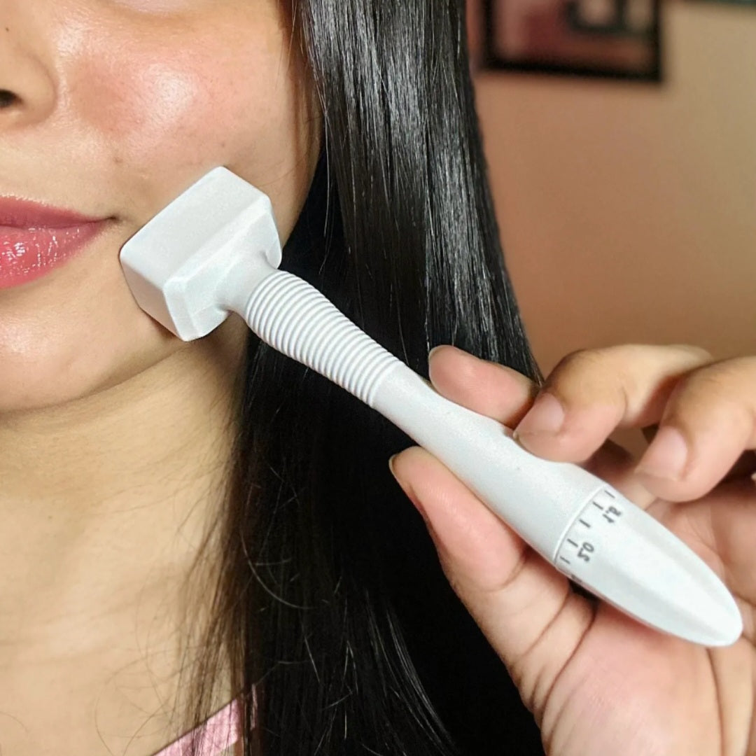 A person demonstrating the application of the DHEO Derma Stamp on the cheek for skin rejuvenation.