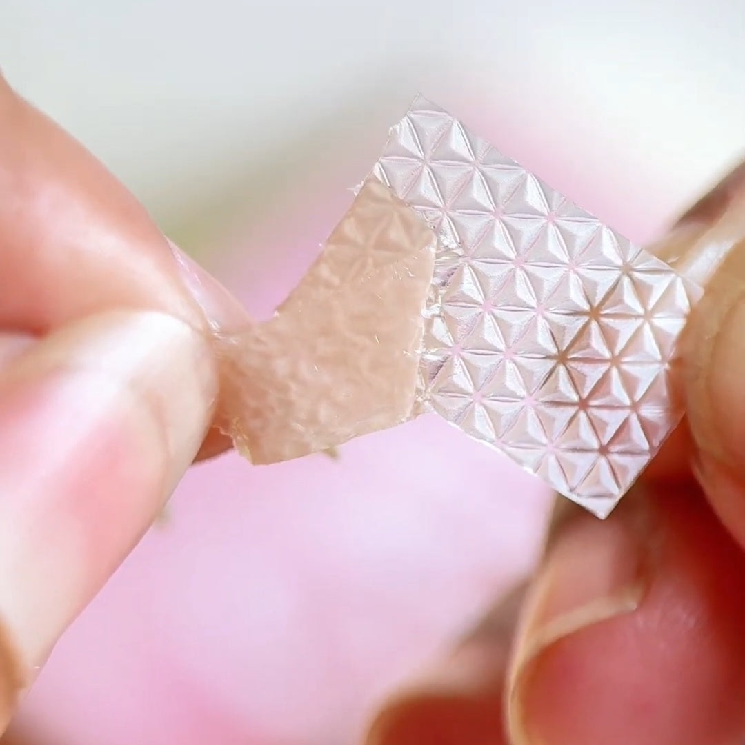 Close-up view of DHEO silicone scar roll, highlighting the textured, breathable adhesive design.