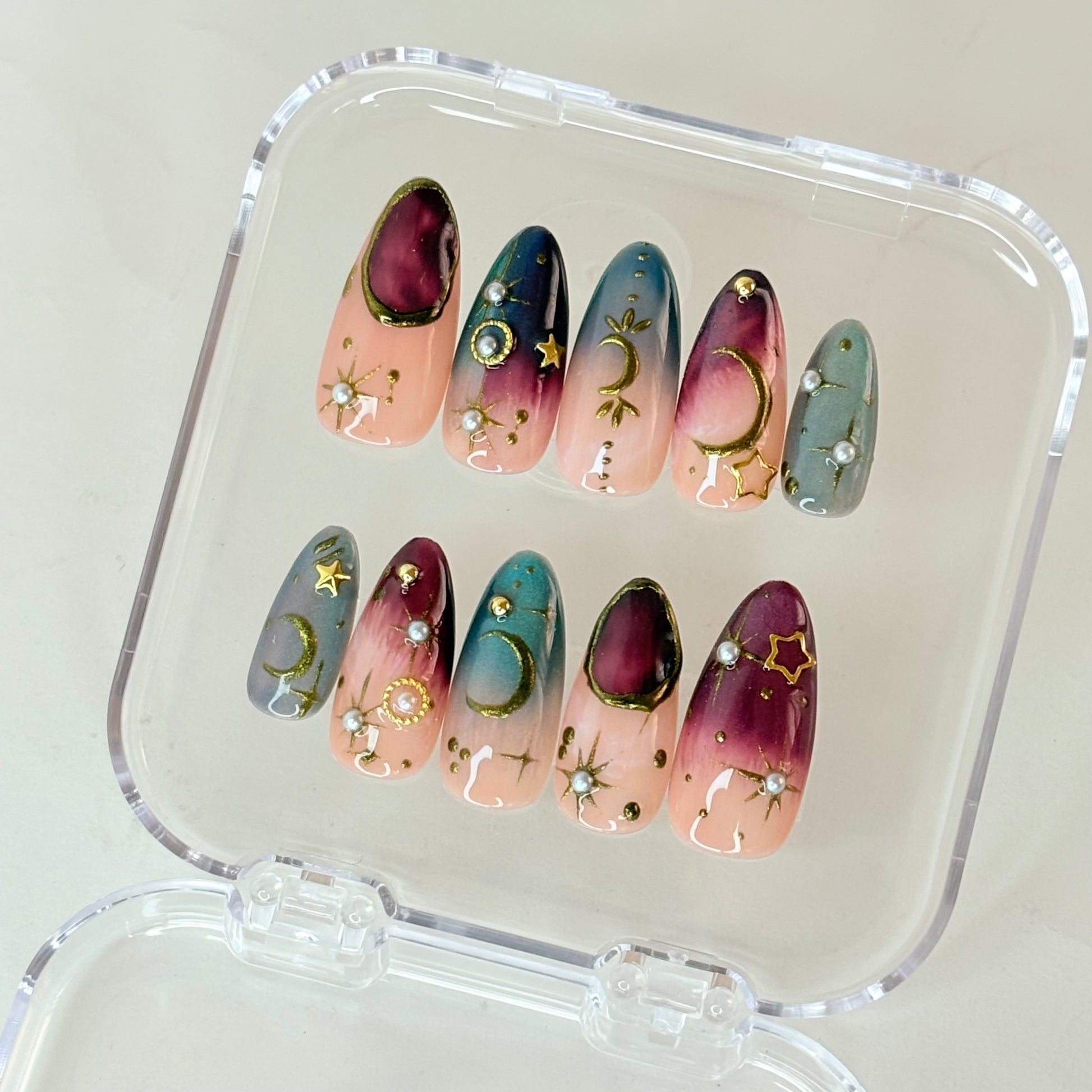 Cosmos Aura press-on nails flat-lay showing deep cosmic purple with stardust finish