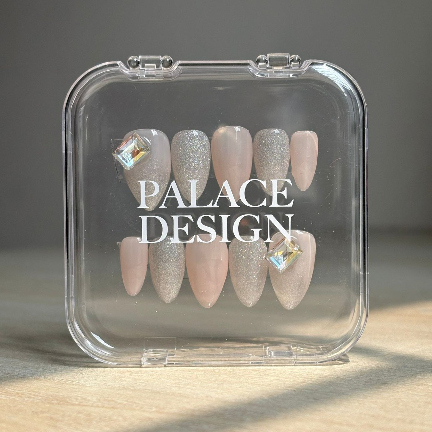 Crystal Luster press-on nails worn on hand showing sparkling crystal clear finish