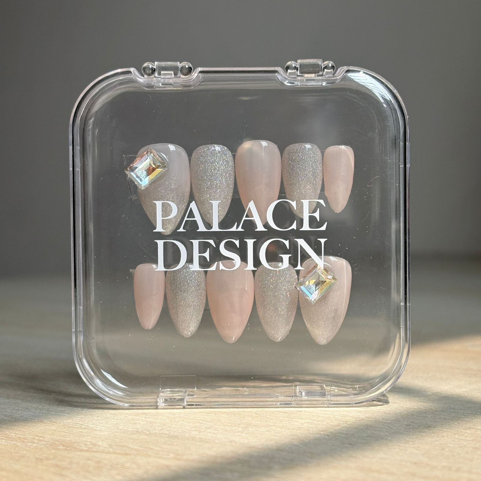 Crystal Luster press-on nails worn on hand showing sparkling crystal clear finish