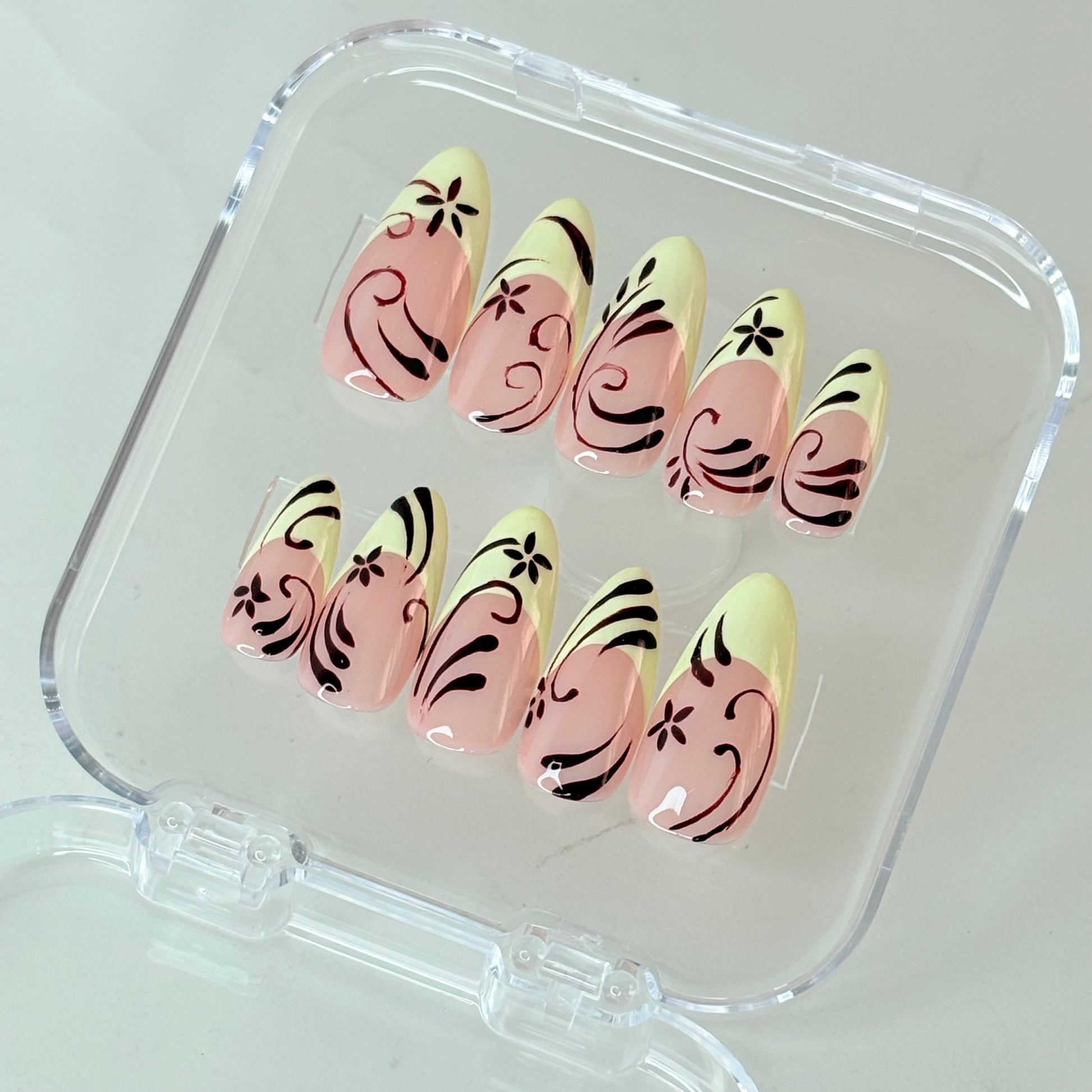 Wildflower press-on nails flat-lay showing multicolour floral art on nude base
