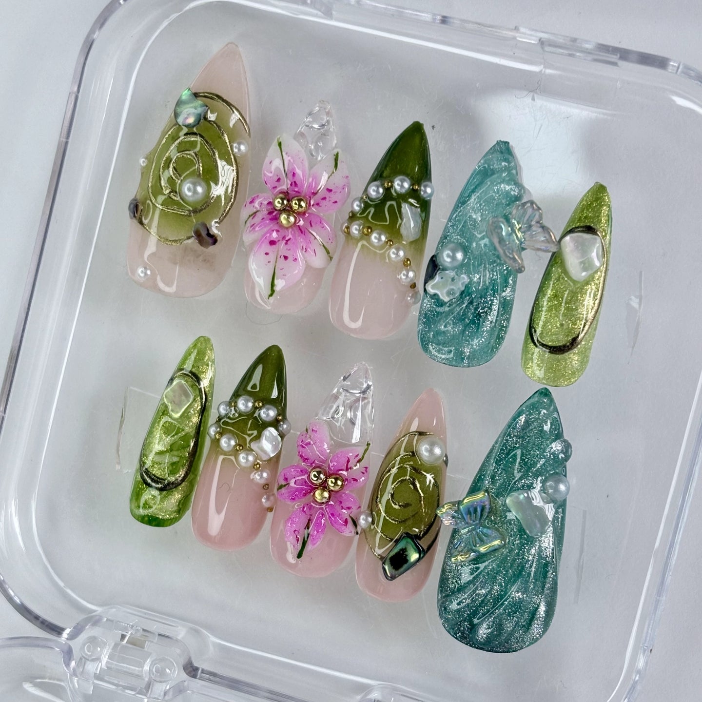 Emerald Reverie press-on nails flat-lay showing deep emerald green with shimmer