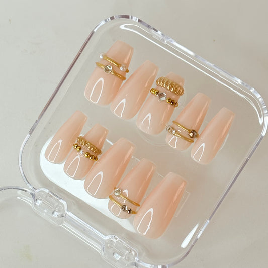 Crowned Glory press-on nails flat-lay showing gold crown art on ivory base