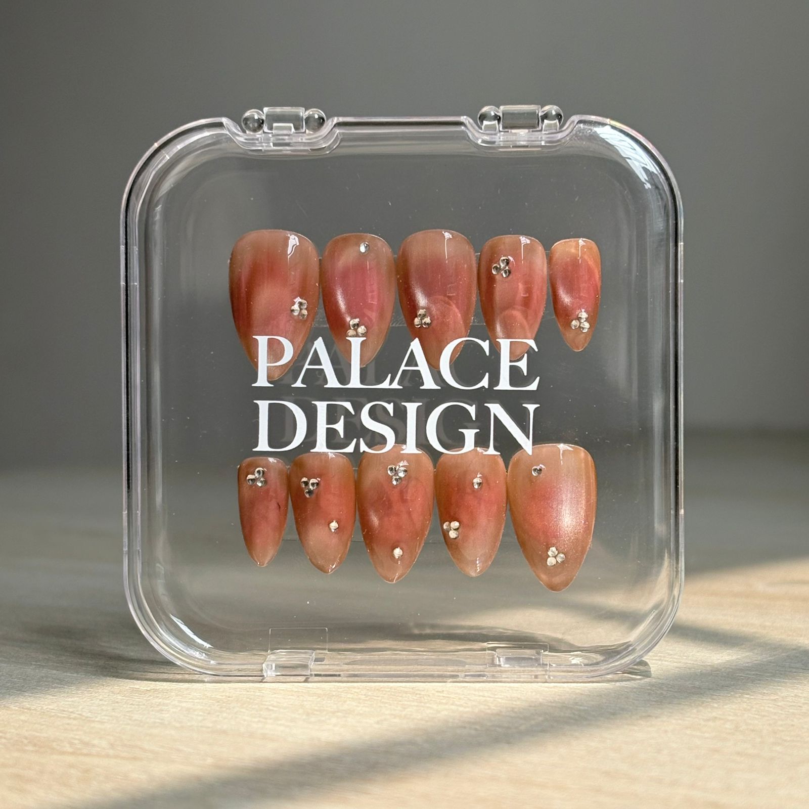 Burnt Sugar press-on nails worn on hand showing toasted caramel finish