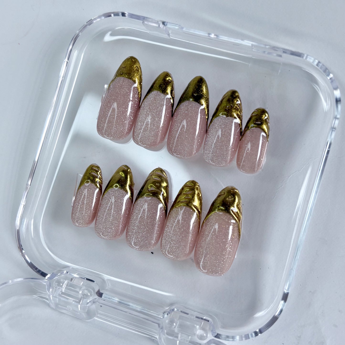 Gilded Olive press-on nails worn on hand showing earthy olive with gold shimmer