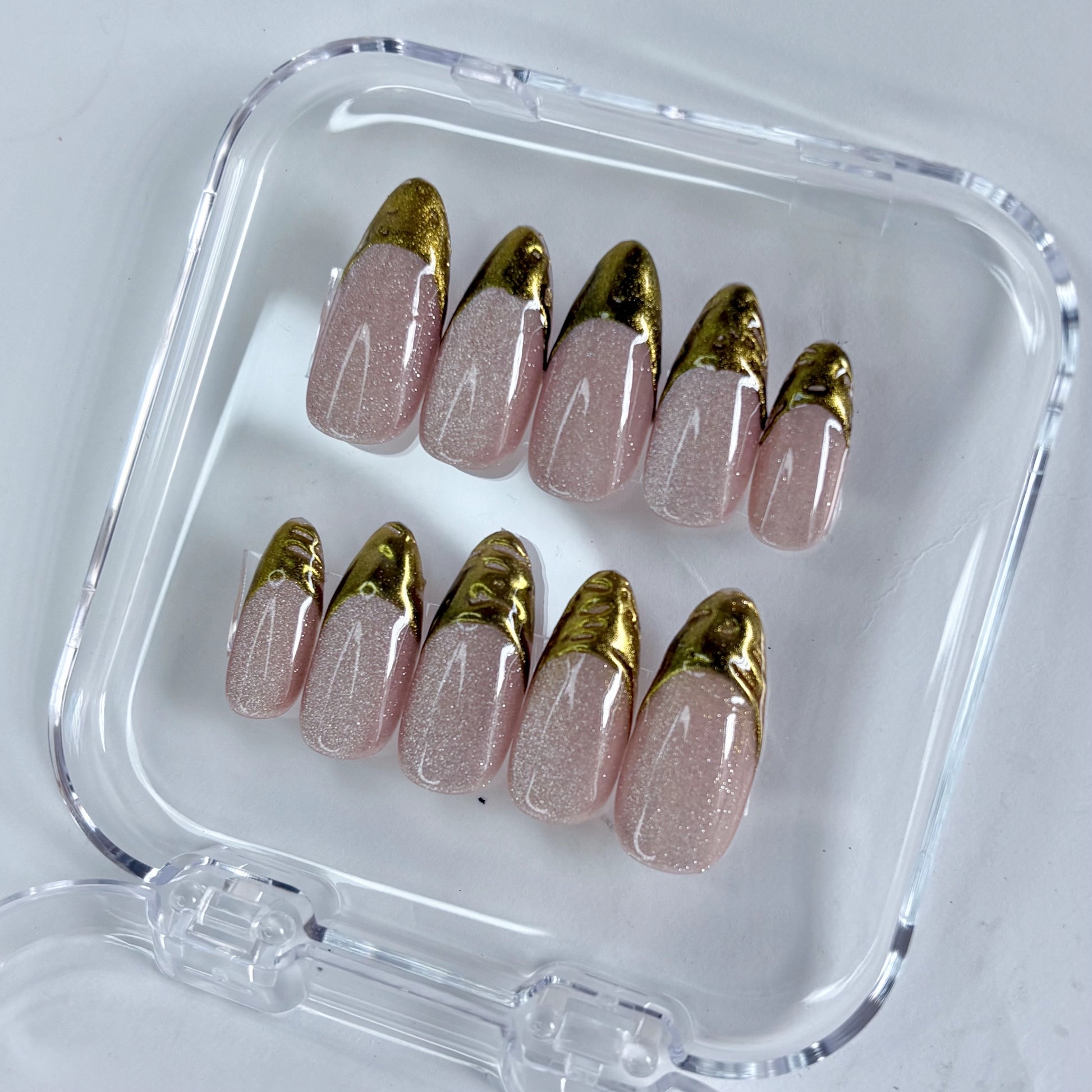 Gilded Olive press-on nails worn on hand showing earthy olive with gold shimmer