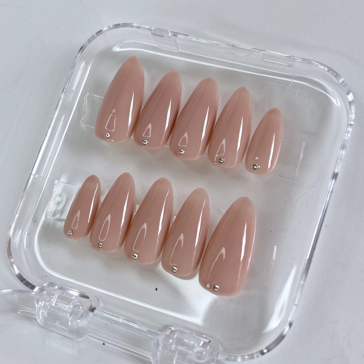 Dot of Grace press-on nails worn on hand showing elegant dotwork nail art