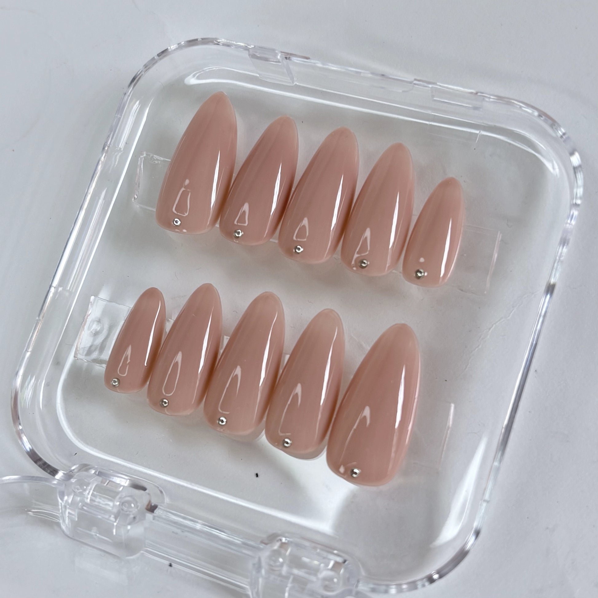 Dot of Grace press-on nails worn on hand showing elegant dotwork nail art