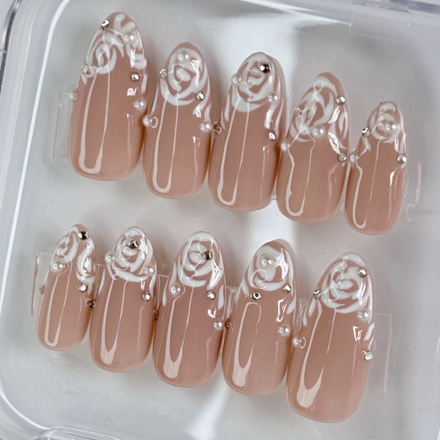 Rose Illusion press-on nails flat-lay showing dusty rose with ombre illusion finish
